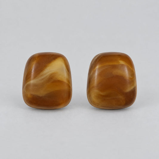 Front view of cognac amber cushion cabochon stud earrings