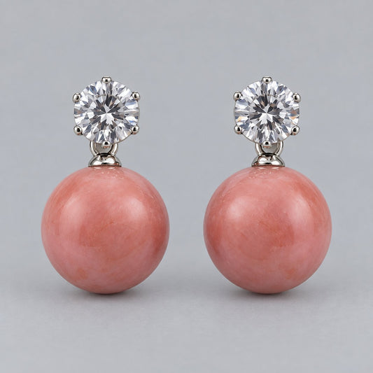 Front view of coral pink orb drop earrings with sparkling round top stones