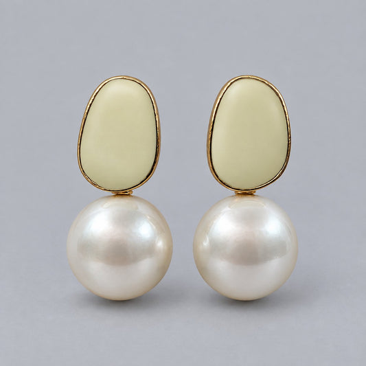 Front view of the gold-tone ivory enamel and faux pearl drop earrings