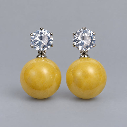 Front view of the silver-tone marigold yellow orb drop earrings
