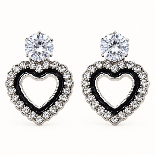 Front view of the silver-tone Noir heart halo drop earrings with black enamel and crystal edge