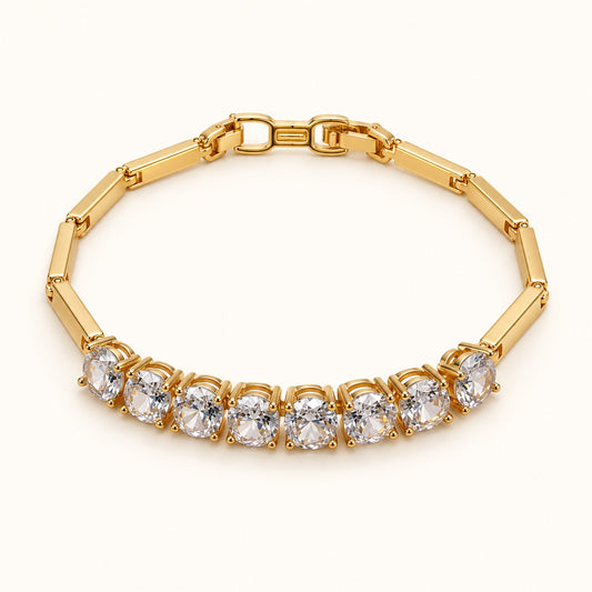 Front view of gold-tone bar-link bracelet with a row of cubic zirconia stones