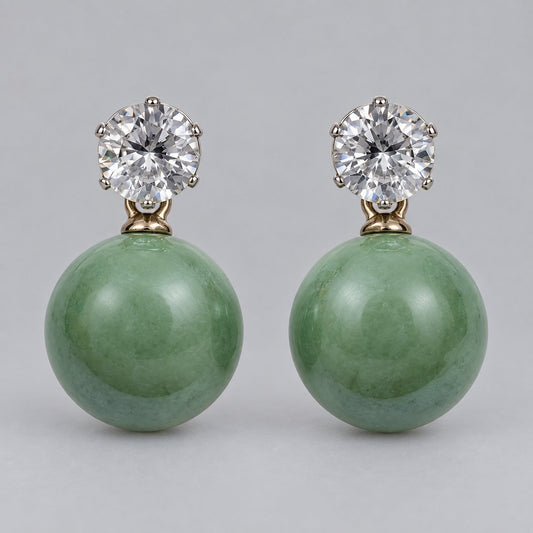Front view of sage green orb drop earrings with sparkling round top stones