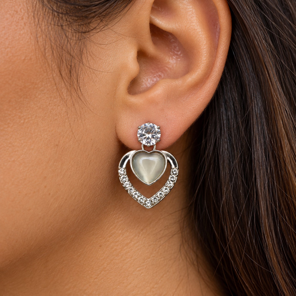 Model wearing Argent Opaline Heart Drops silver-tone drop earrings
