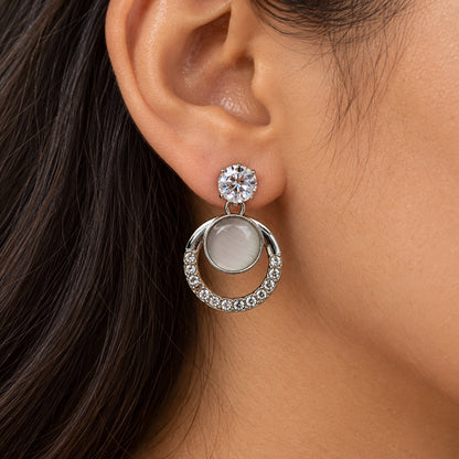 Model wearing Argent Opaline Orbit Drops silver-tone drop earrings