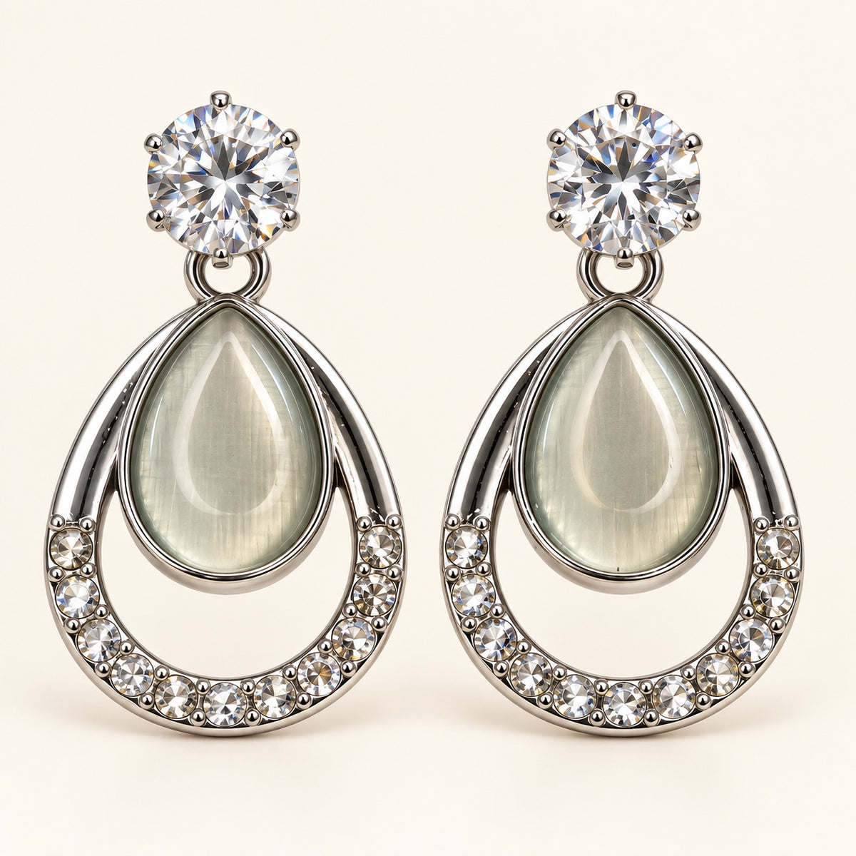 Front view of silver-tone opaline teardrop drop earrings with crystal-lined frame