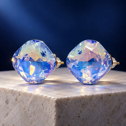 Aurora Blue Crystal Studs iridescent cushion-cut stud earrings with gold-tone posts on a stone block