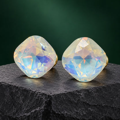 Aurora White Crystal Studs pearly cushion-cut stud earrings with gold-tone posts on a dark stone block