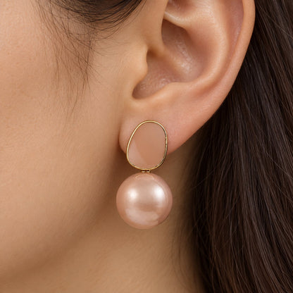 Model wearing Blush Pebble Pearl Drops gold-tone earrings