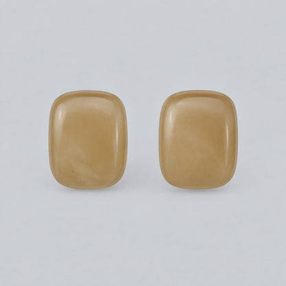 Front view of champagne cushion cabochon stud earrings with gold-tone rim
