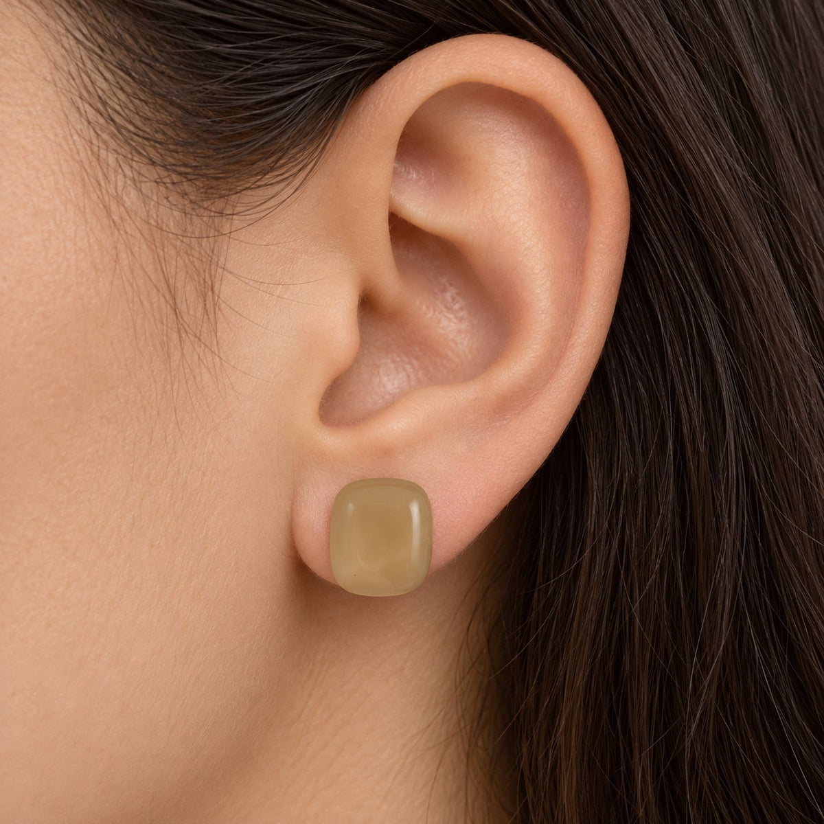 Model wearing Champagne Cabochon Studs gold-tone cushion earrings