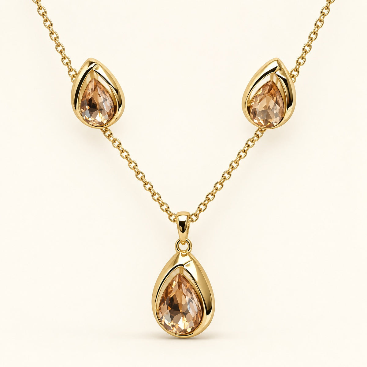 Front view of champagne teardrop necklace and matching earrings in gold-tone settings