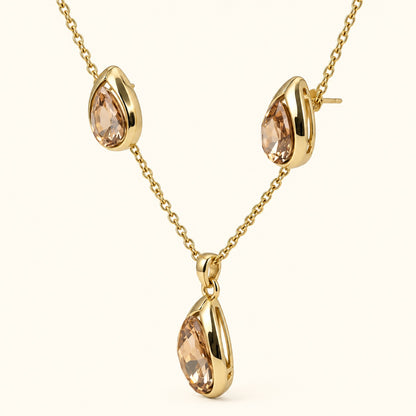 Side view of champagne teardrop necklace set showing the curved gold-tone bezels
