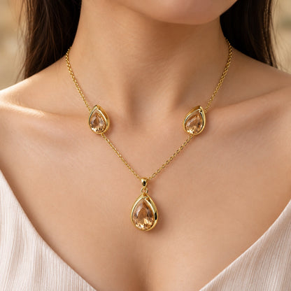 Model wearing Champagne Teardrop Necklace Set gold-tone necklace with champagne stones