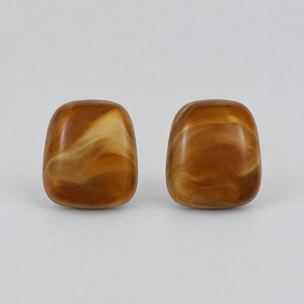 Front view of cognac amber cushion cabochon stud earrings