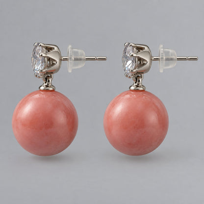 Side view of coral pink lustre orb drop earrings showing the drop length