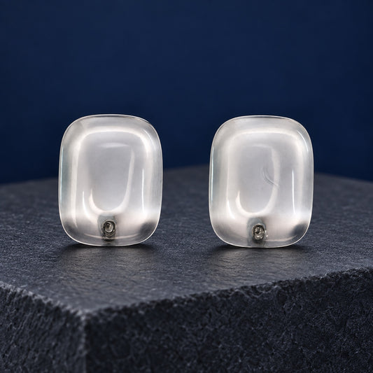 Crystal Clear Cabochon Studs transparent cushion stud earrings with silver-tone posts on a marble block