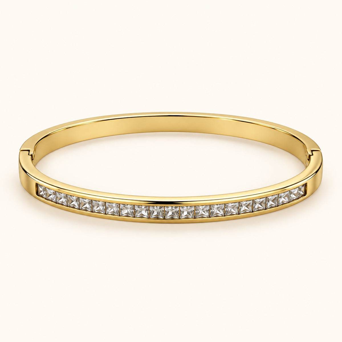 Front view of gold-tone bangle with channel-set square-cut cubic zirconia stones