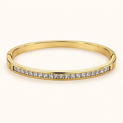 Front view of gold-tone bangle with channel-set square-cut cubic zirconia stones