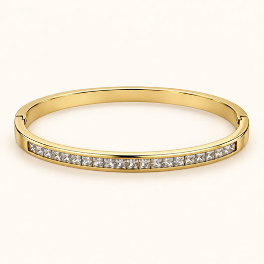 Front view of gold-tone bangle with channel-set square-cut cubic zirconia stones