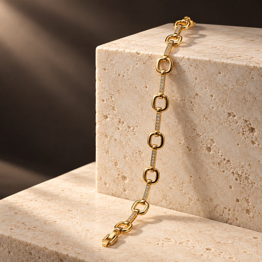 Gilded Cushion Link Bracelet gold-tone chain with sparkling stone bars on travertine steps