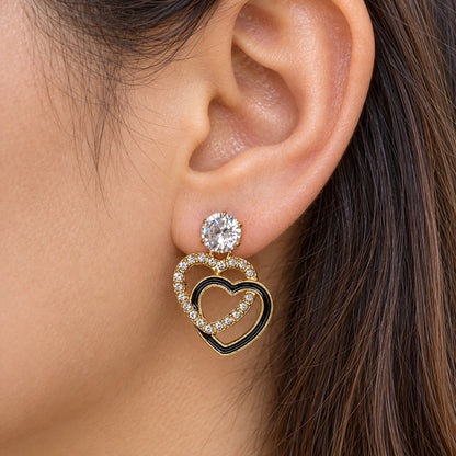 Gilded Noir Heart Drops gold-tone heart drop earrings worn on model
