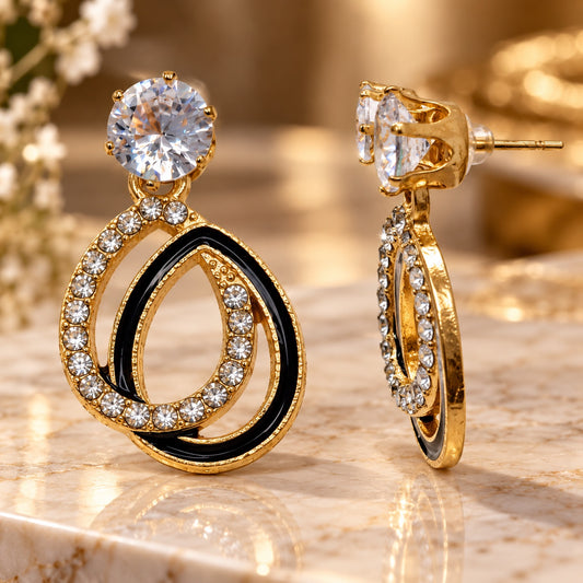 Gilded Noir Teardrop Earrings gold-tone teardrop earrings styled on cream marble
