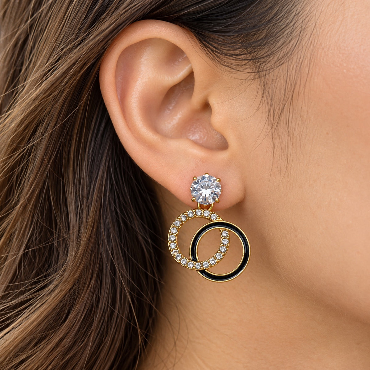 Gilded Noir Twin Orbit Drops gold-tone twin orbit drop earrings worn on model