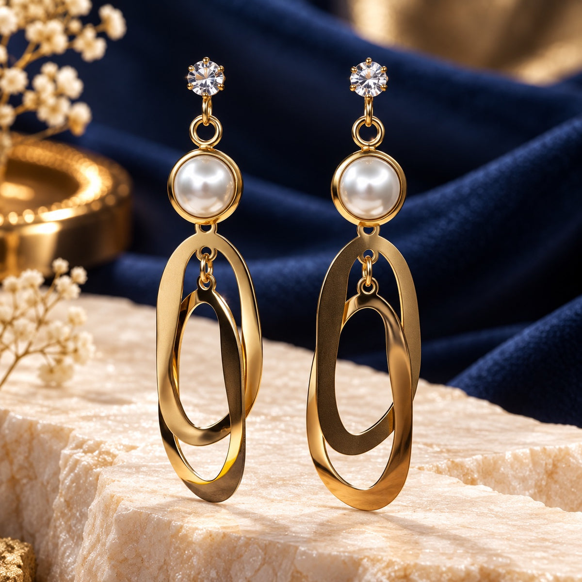 Gilded Pearl Oval Loop Drops gold-tone pearl oval loop drop earrings styled on cream marble