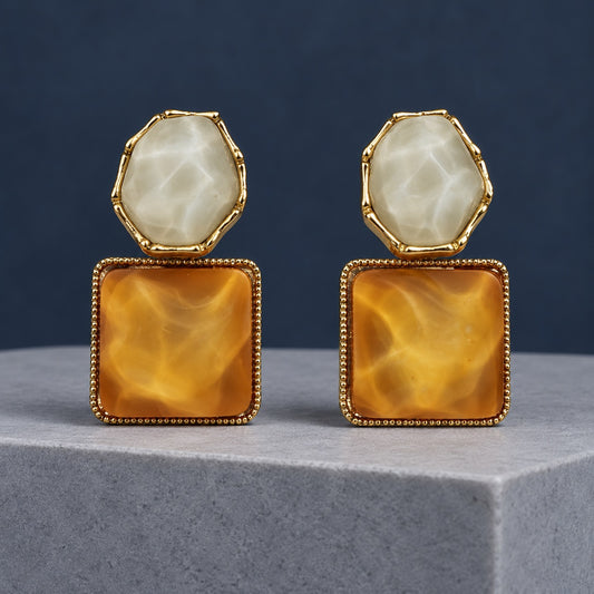 Golden Amber Marble Square Drop Earrings with a milky stone top and amber square drop on a marble stand
