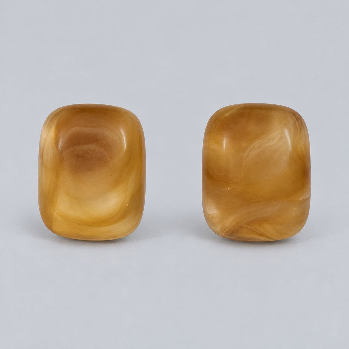 Front view of the golden honey cushion cabochon stud earrings