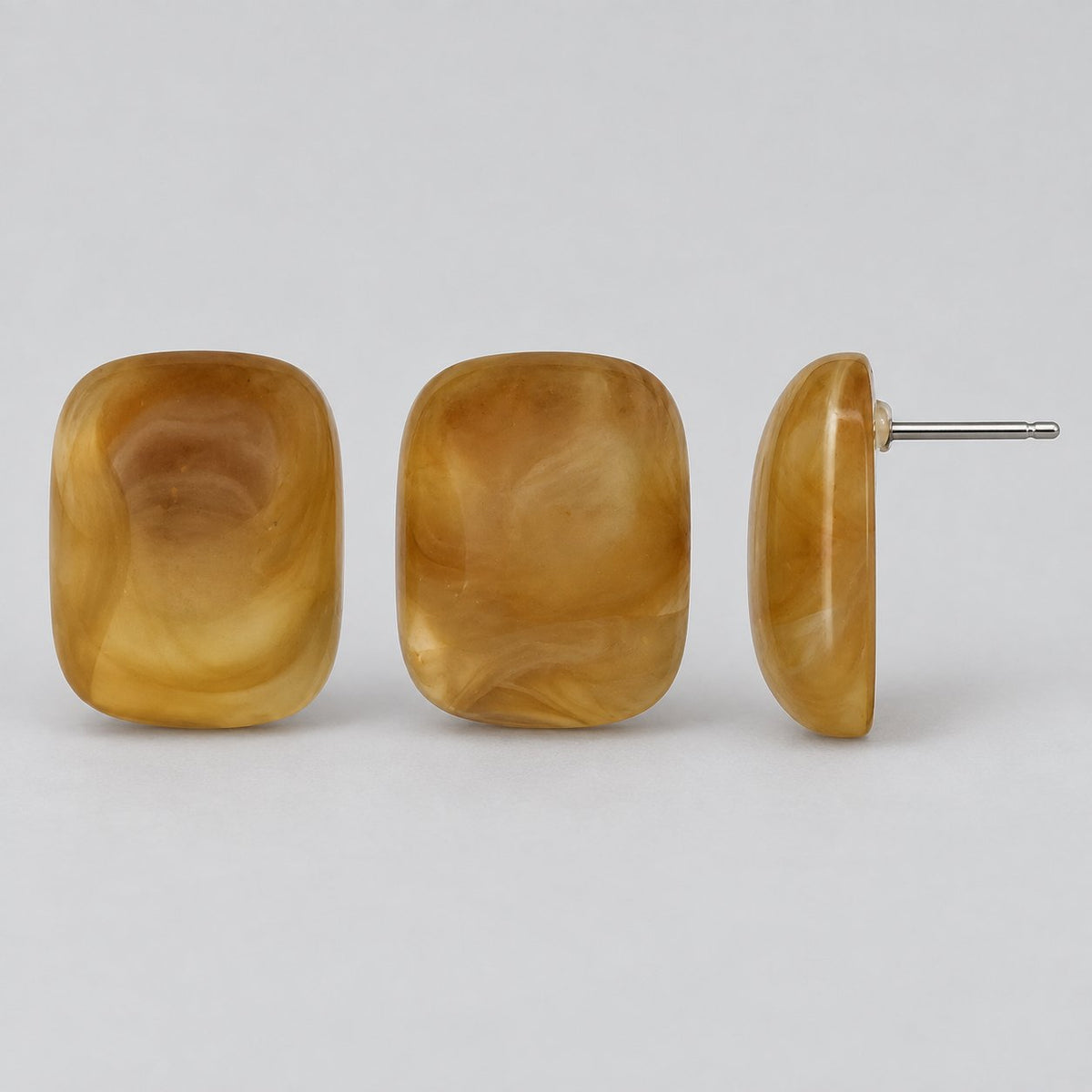 Side view of the Golden Honey Swirl Cabochon Studs showing the domed profile
