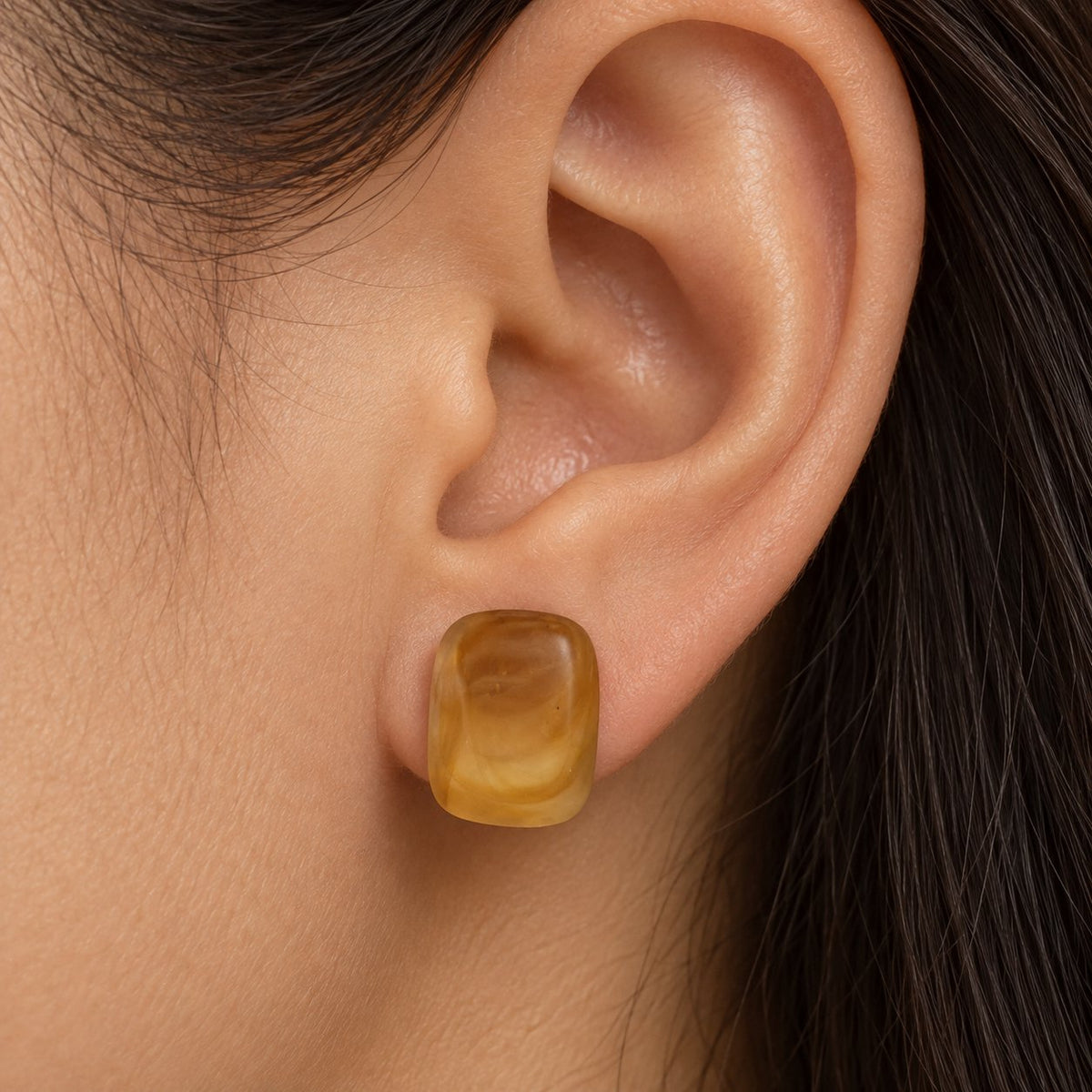Model wearing the Golden Honey Swirl Cabochon Studs