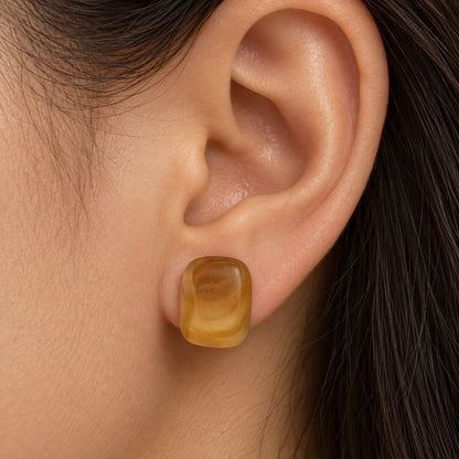Model wearing the Golden Honey Swirl Cabochon Studs
