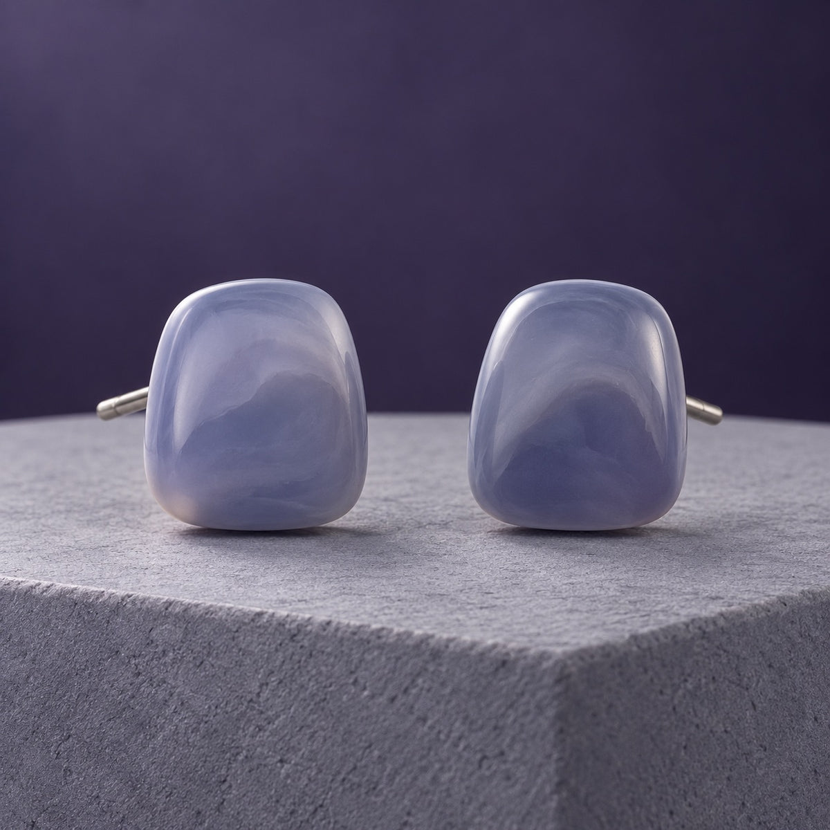 Lavender Mist Cabochon Studs with smoky lavender marbled stones on a marble ledge
