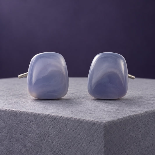 Lavender Mist Cabochon Studs with smoky lavender marbled stones on a marble ledge