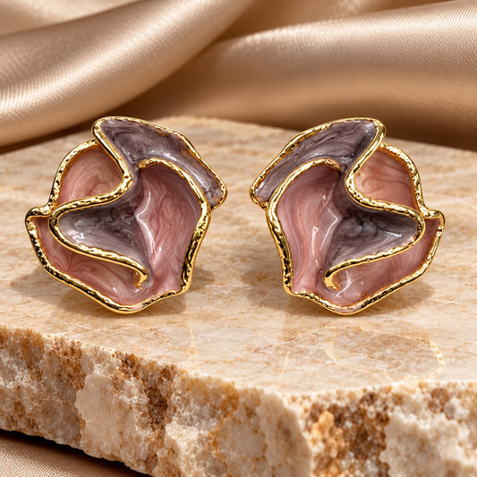 Lilac Blossom Enamel Studs with ruffled mauve and lilac petals outlined in gold tone on a stone ledge