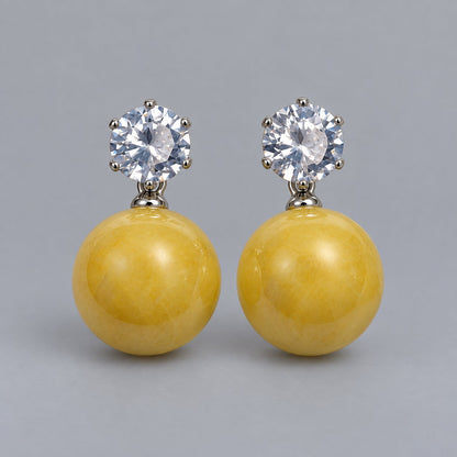Front view of the silver-tone marigold yellow orb drop earrings