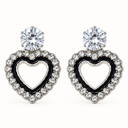 Front view of the silver-tone Noir heart halo drop earrings with black enamel and crystal edge