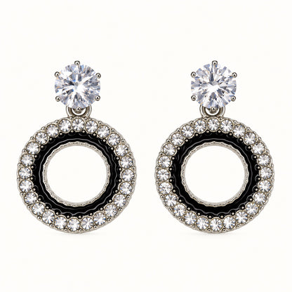 Front view of the silver-tone Noir orbit halo drop earrings with black enamel and crystal edge