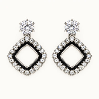 Front view of the silver-tone Noir rhombus halo drop earrings with black enamel and crystal edge