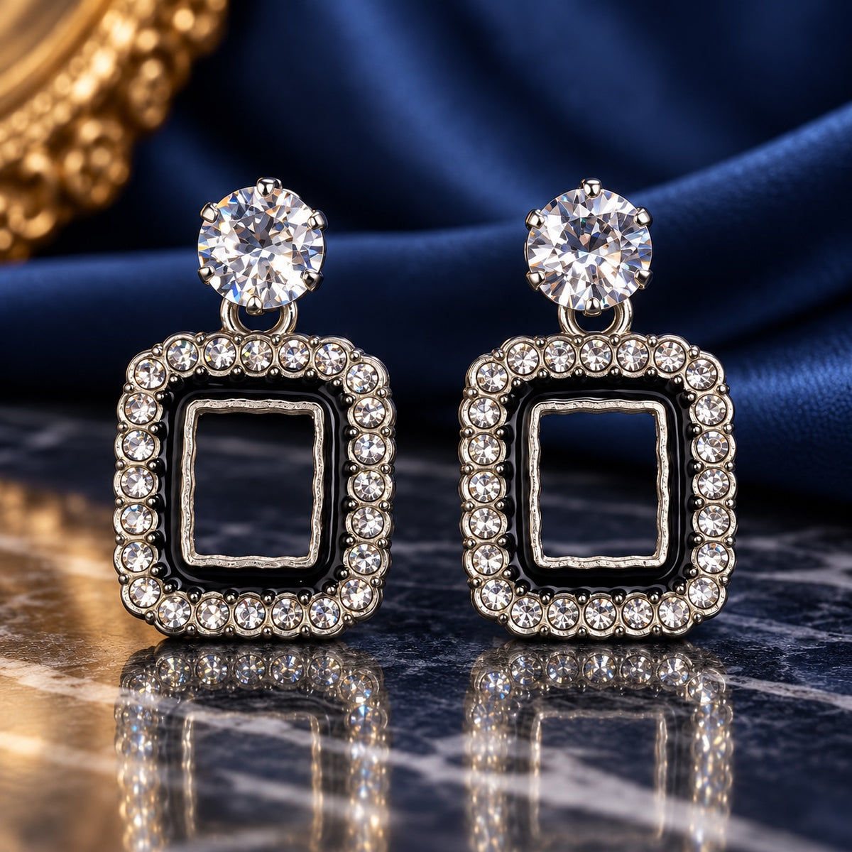 Noir Square Halo Drops with sparkling stone tops and black enamel square halos on a marble surface