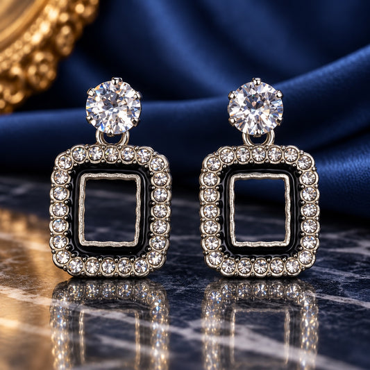 Noir Square Halo Drops with sparkling stone tops and black enamel square halos on a marble surface