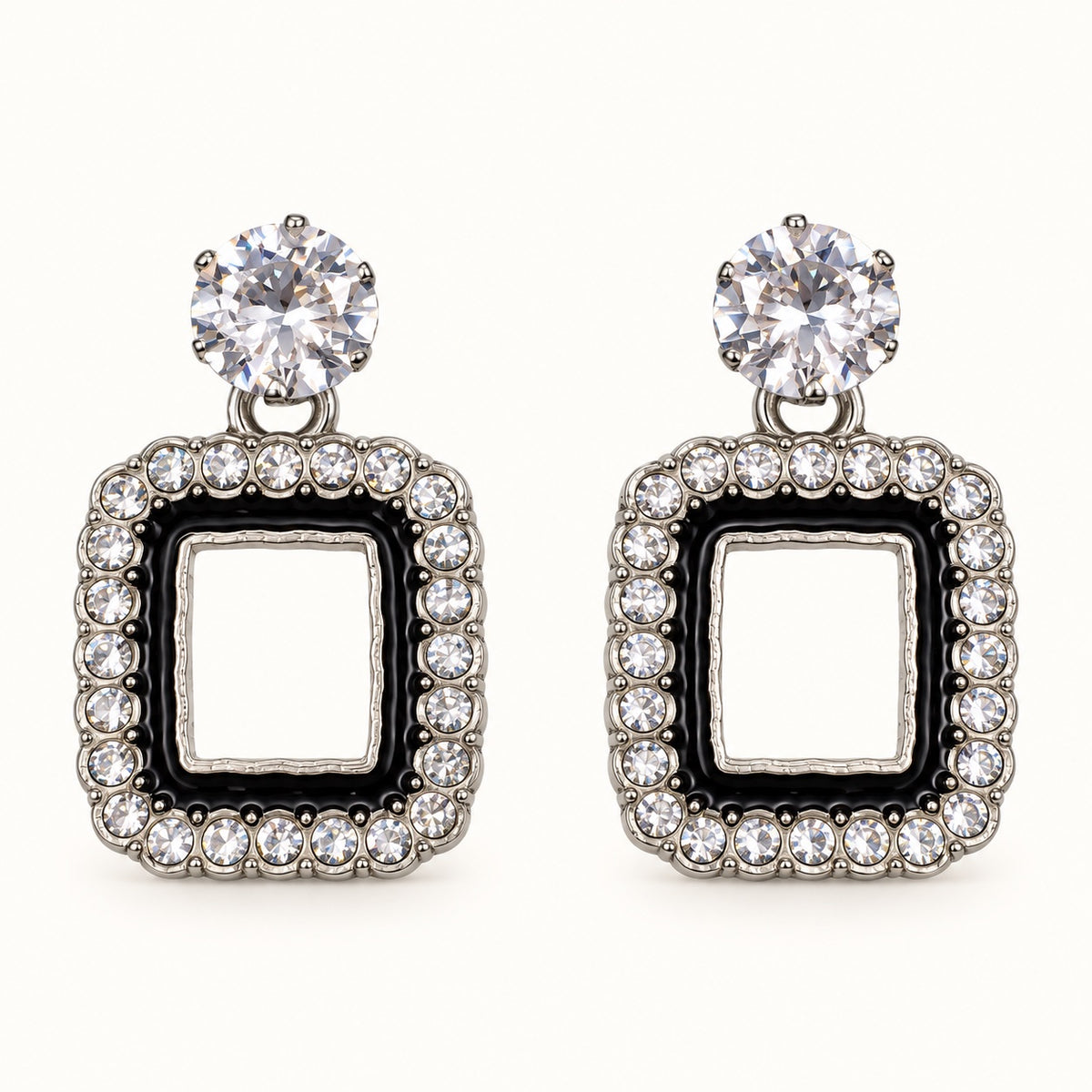 Front view of the silver-tone Noir square halo drop earrings with black enamel and crystal edge