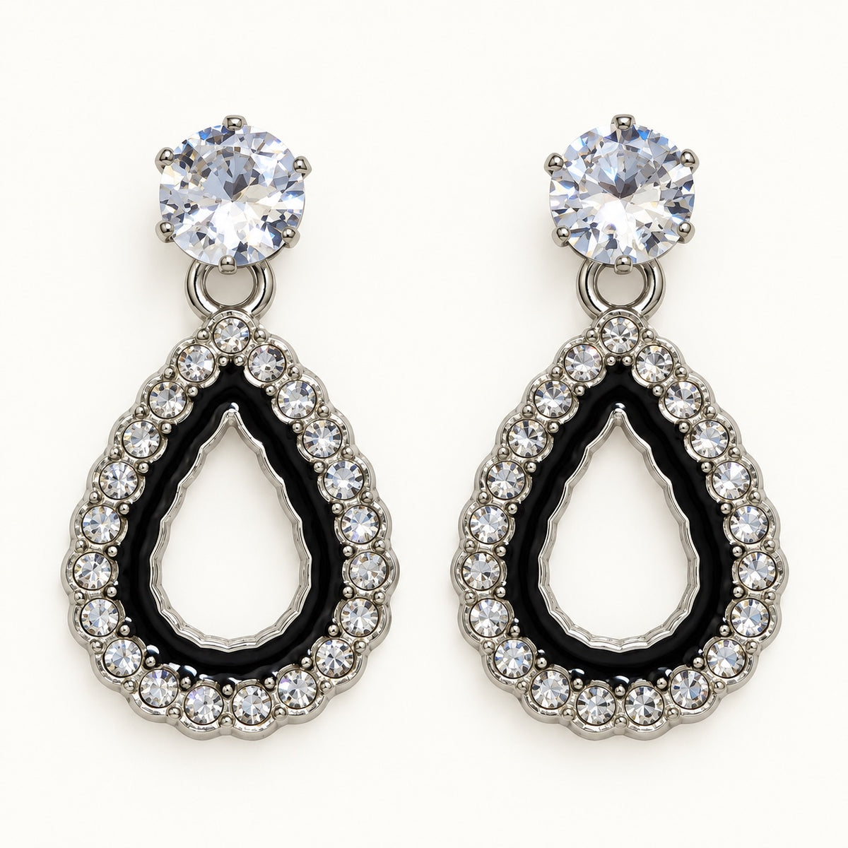 Front view of silver-tone teardrop halo drop earrings with cubic zirconia studs and black enamel