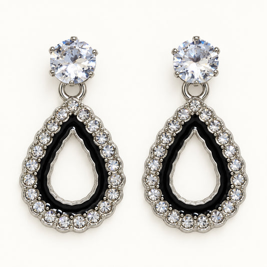 Front view of silver-tone teardrop halo drop earrings with cubic zirconia studs and black enamel
