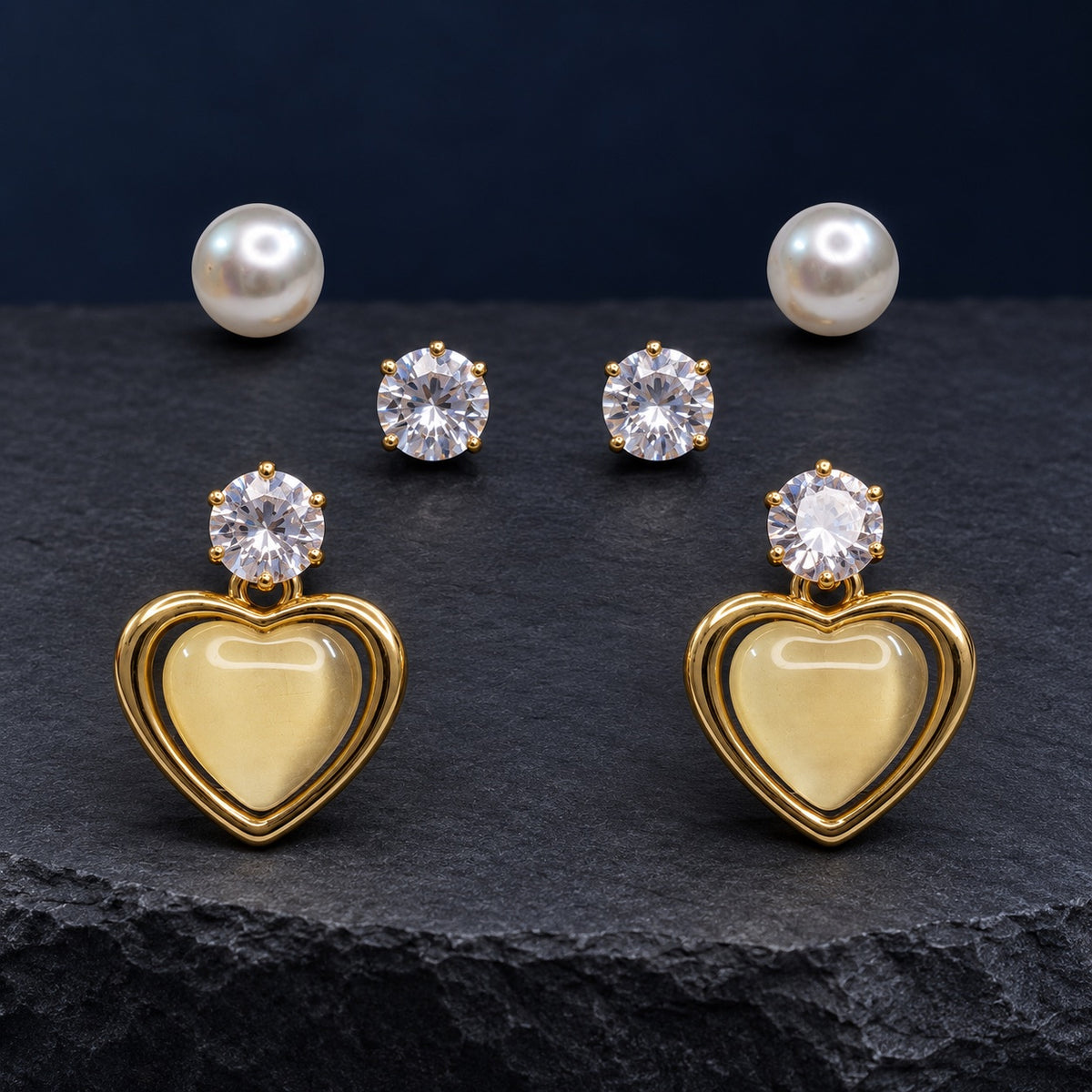 Opaline Heart Earring Trio Set with pearl studs, zirconia studs and gold heart drops on satin