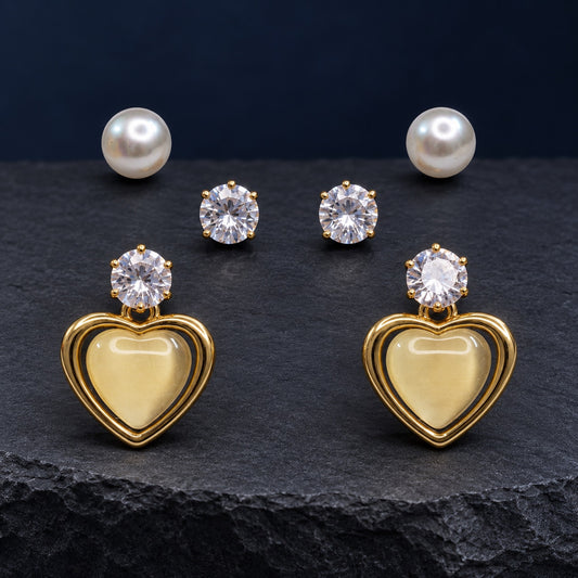 Opaline Heart Earring Trio Set with pearl studs, zirconia studs and gold heart drops on satin