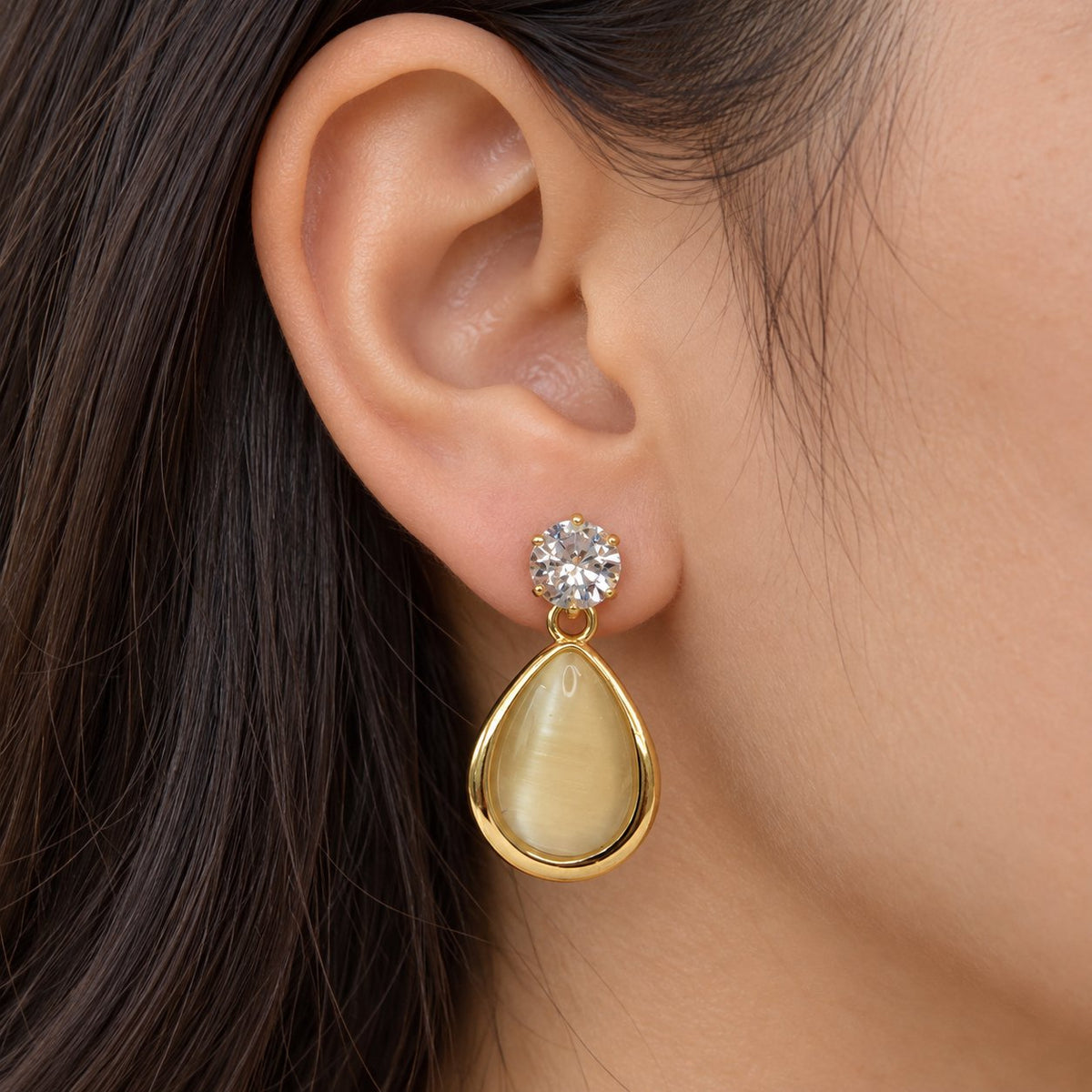 Model wearing Opaline Teardrop Earring Trio stacked on one ear