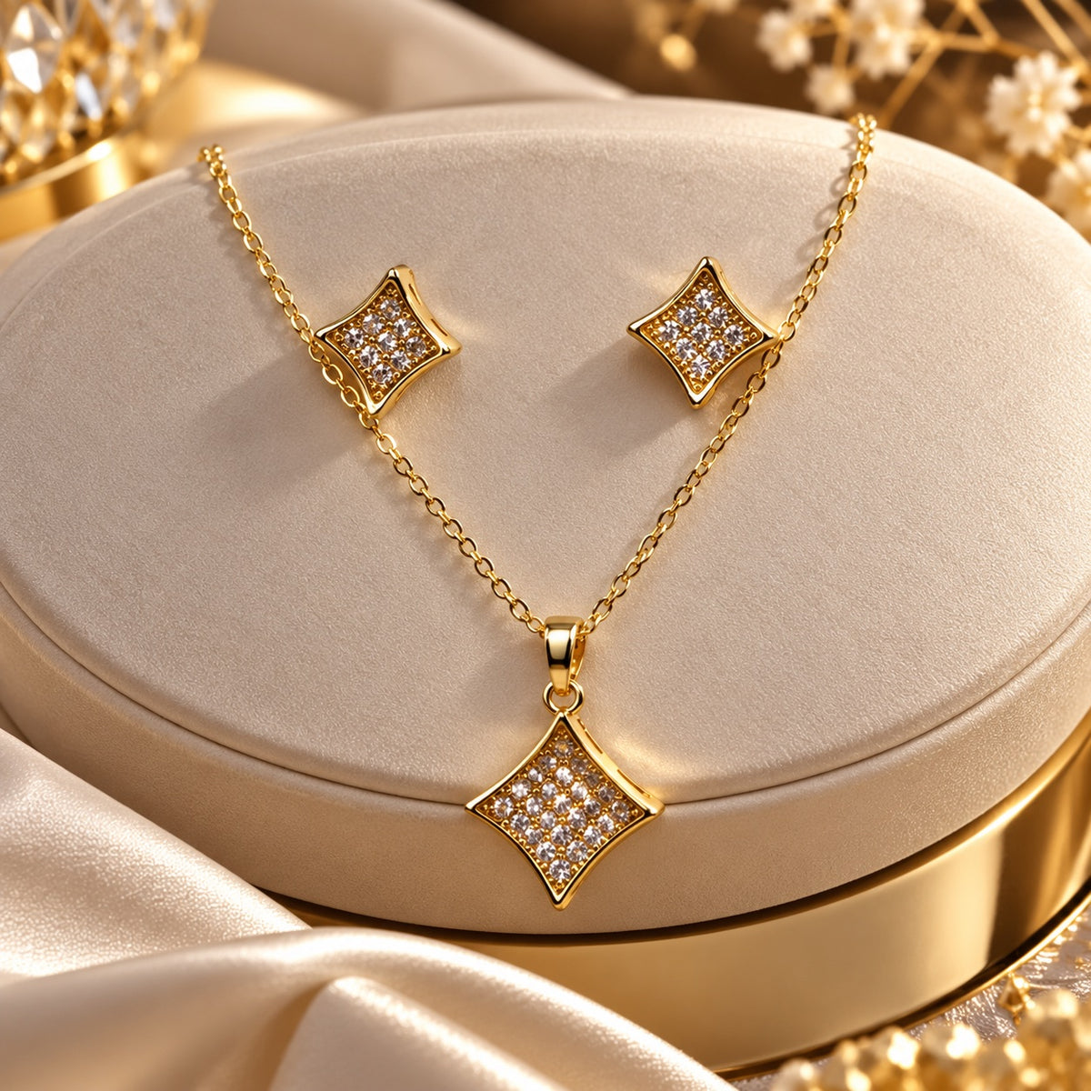 Pavé Rhombus Necklace Set in gold tone with matching studs on a cream jewellery box